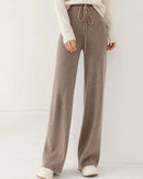 Woman heading to work in 100 % Merino-Wool Knitted Wide-Leg Trousers, 19.5 micron superfine knit drapes like jersey—your polished yet cozy 45-65 °F fall-to-spring commuter layer.