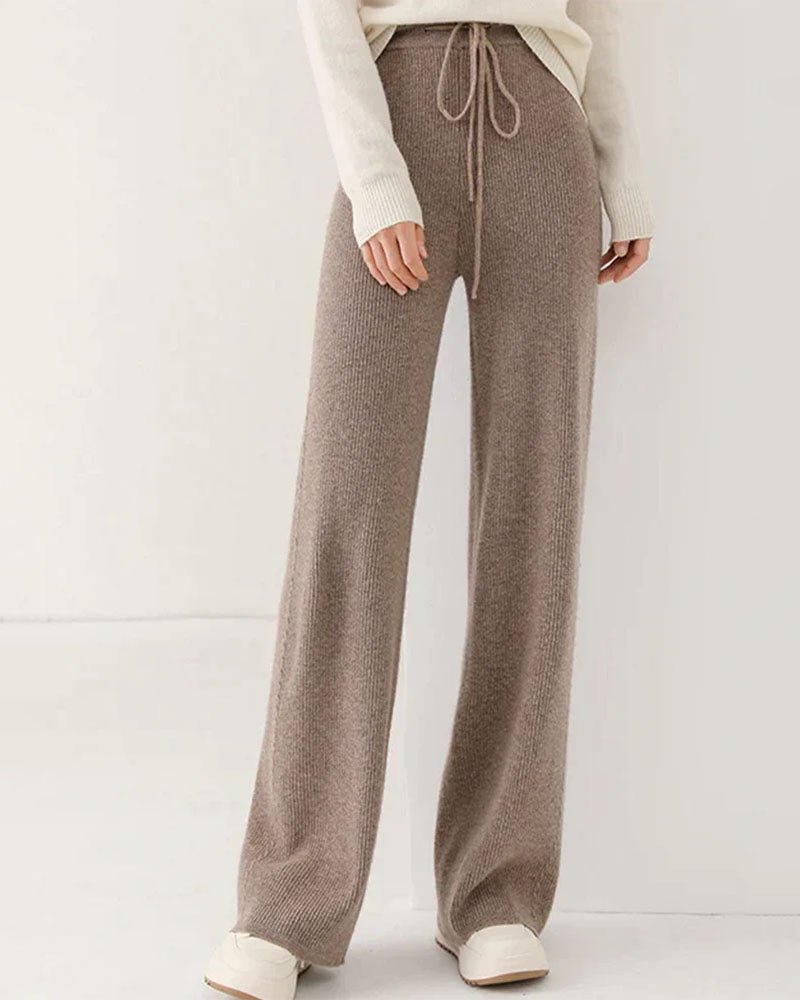 Woman heading to work in 100 % Merino-Wool Knitted Wide-Leg Trousers, 19.5 micron superfine knit drapes like jersey—your polished yet cozy 45-65 °F fall-to-spring commuter layer.