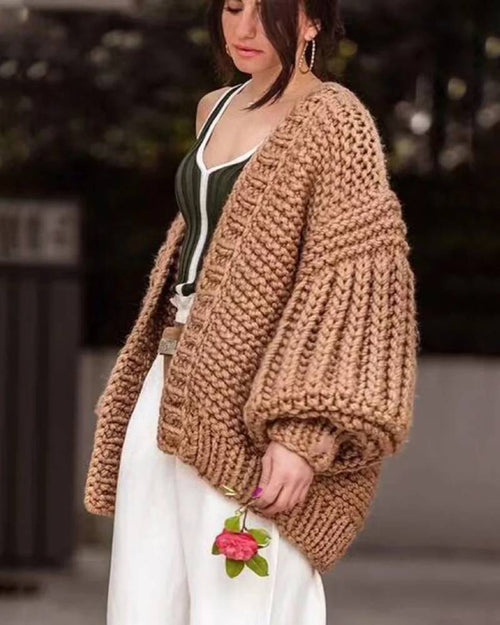Unisex boho knit cardigan, dropped lantern shoulders, side slits, tassel fringe, storm-gray hue—breathable warmth that elevates denim or maxi dresses.