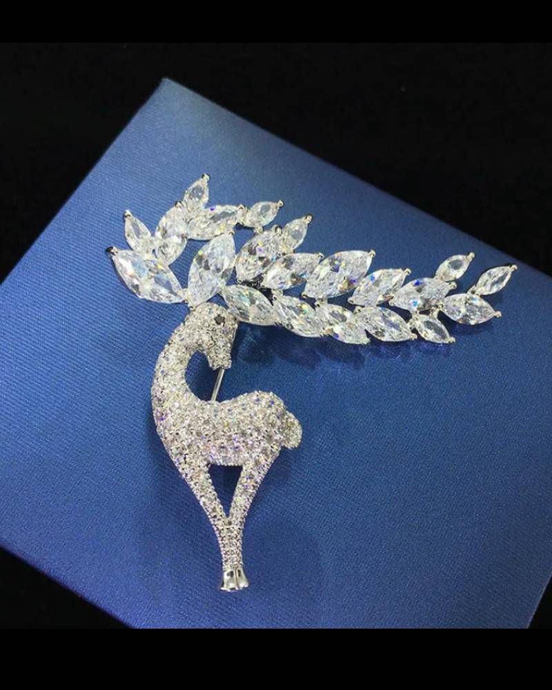 Sparkling silver-tone reindeer brooch pin paved with clear rhinestones, festive holiday accent for coats, scarves or stockings.