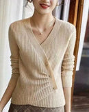 Woman city-walking in the Designers V-Neck Wool Sweater with Asymmetrical Buttons, 100 % superfine Merino drapes like jersey—your luxe yet breathable 60-75 °F spring-fall statement.