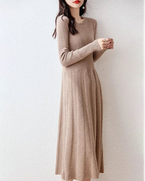 Woman posing in a Merino Wool Knitted Sweater Dress, 100 % superfine Merino rib drapes like jersey—your luxe yet breathable 60-75 °F spring-fall statement.
