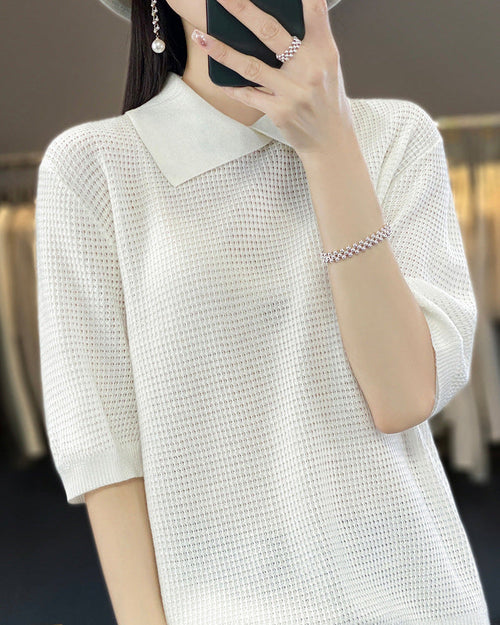 Women's loose-fit short-sleeve polo sweater made from soft [Material] featuring a classic collar and relaxed silhouette perfect for layering.