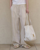 Elevate your warm-weather wardrobe with our relaxed linen drawstring wide leg pants.