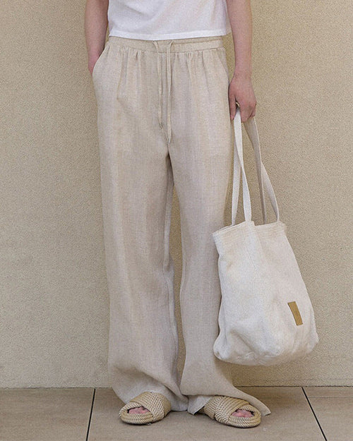 Elevate your warm-weather wardrobe with our relaxed linen drawstring wide leg pants.