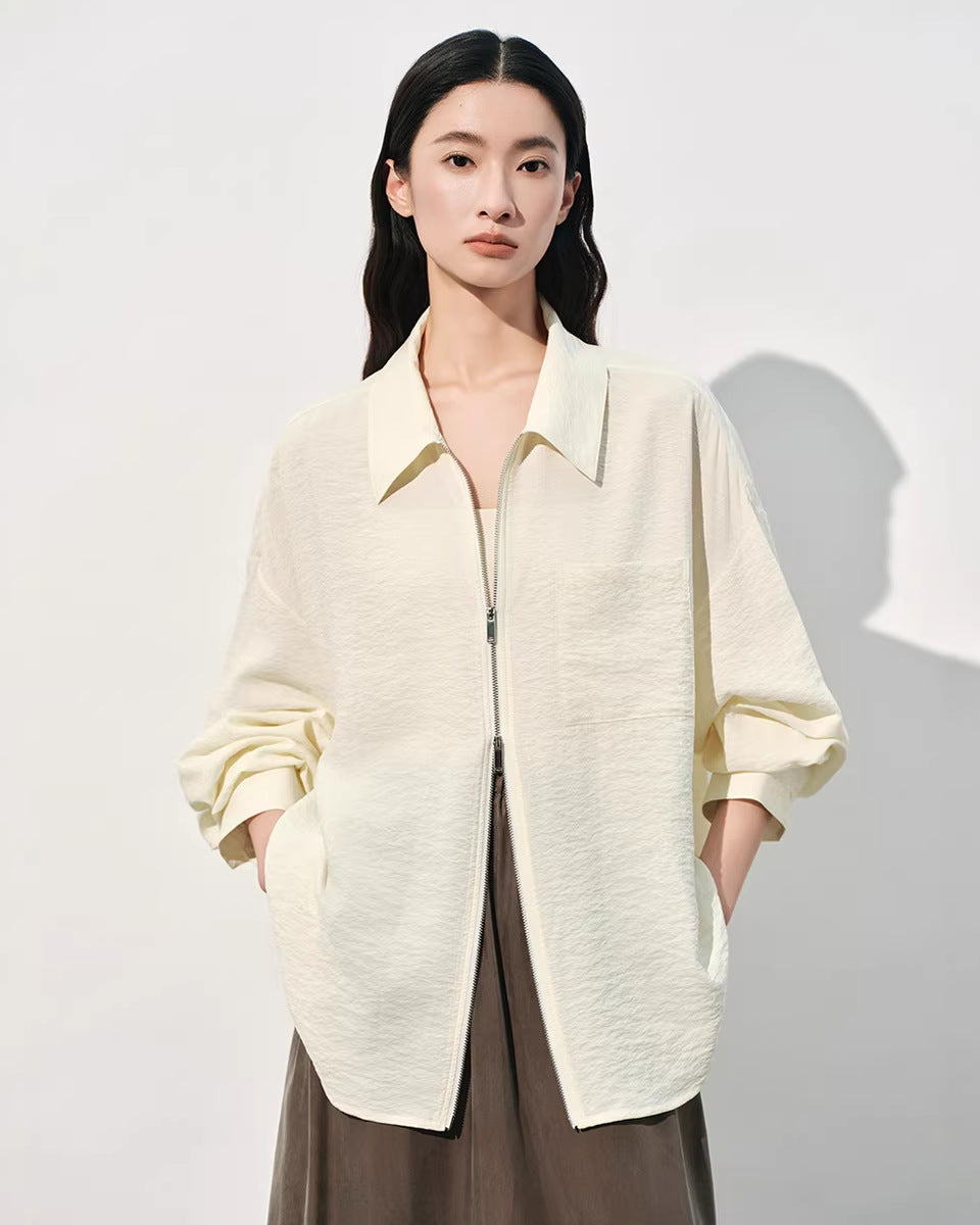 White loose-fit polo-collar zip shirt for women crafted from a premium mulberry silk blend, featuring a textured jacquard finish and a relaxed oversized silhouette.