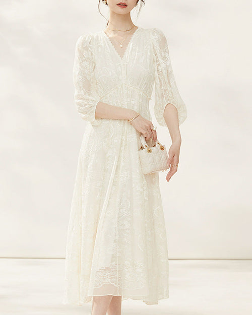 Women's silk dress featuring intricate [Pattern] embroidery and elegant three-quarter sleeves, offering a sophisticated silhouette perfect for formal events.