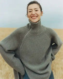Oversized 100 % cashmere sweater, irregular diagonal zipper at high neck, dropped shoulders, ribbed cuffs, heather taupe—runway-ready winter layer for him or her.