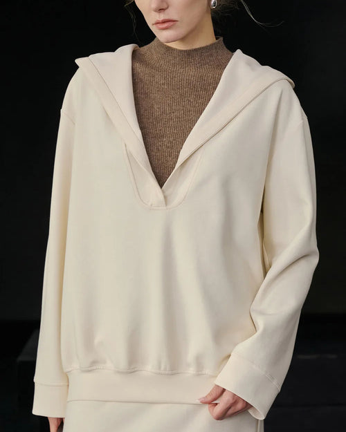 Women's Hooded loose pullover sweatshirt crafted from soft medium-weight polyester broadcloth, featuring an adjustable hood and relaxed silhouette that skims over layers for cozy comfort in air-conditioned spaces.
