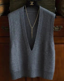 Woman layering a sand-beige deep-v-neck wool vest, 19.5 micron superfine knit and wide lapels give minimalist 90s vibes—your breathable 60-75 °F spring-fall layer.