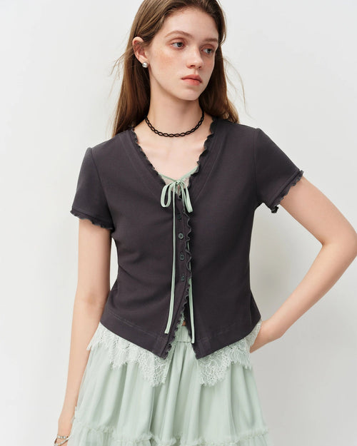 Knit cotton V-neck top with bow-tie front & lace appliqué in a chic mock two-piece design. Sweet, effortless style for summer days and nights out.