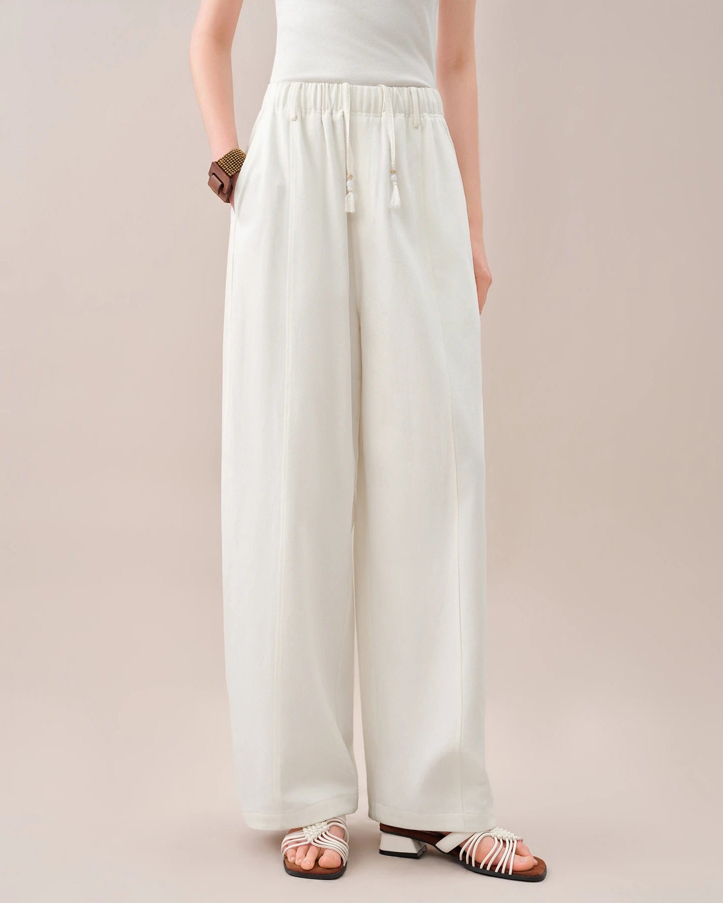 High-waisted loose-fitting curved pants featuring a relaxed silhouette and a unique curved leg shape. These comfortable trousers offer a trendy, flowy fit perfect for casual daily wear and effortless chic styling.