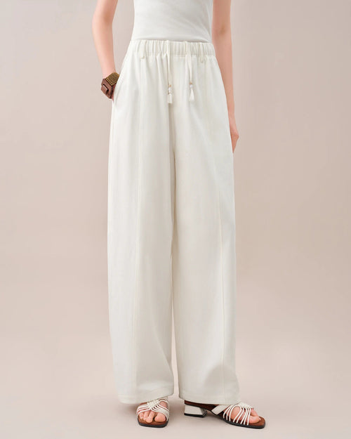 High-waisted loose-fitting curved pants featuring a relaxed silhouette and a unique curved leg shape. These comfortable trousers offer a trendy, flowy fit perfect for casual daily wear and effortless chic styling.