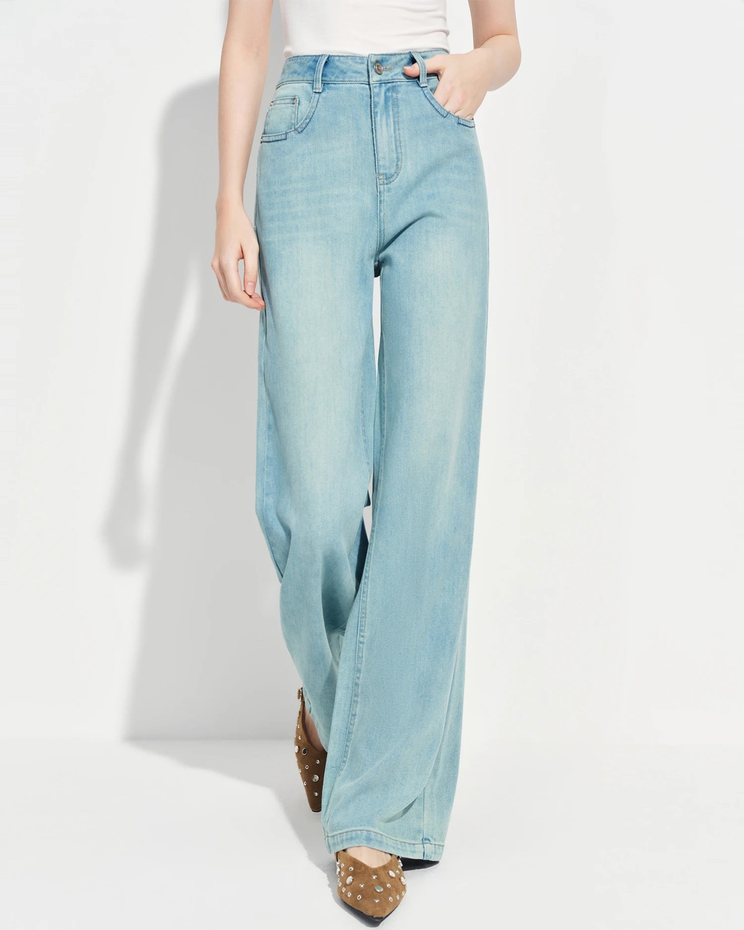 Premium loose-fitting high-waisted straight-leg jeans crafted from a breathable cotton blend, offering medium stretch and a minimal design for effortless spring style.