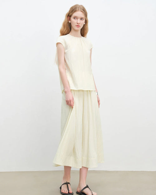 Women's sleeveless top and A-line skirt set, featuring breathable viscose blend and high waist silhouette for spring-summer office wear or resort vacation.