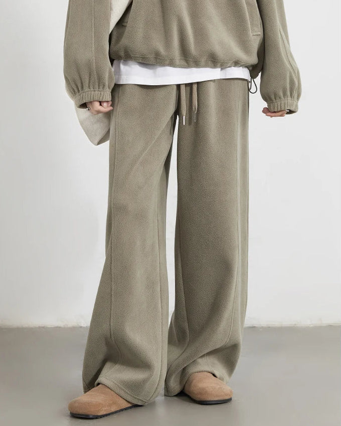 Women's green granular velvet wide-leg pants with elastic waist and opaque laminated fabric, delivering sporty office-ready comfort for autumn and winter layering.