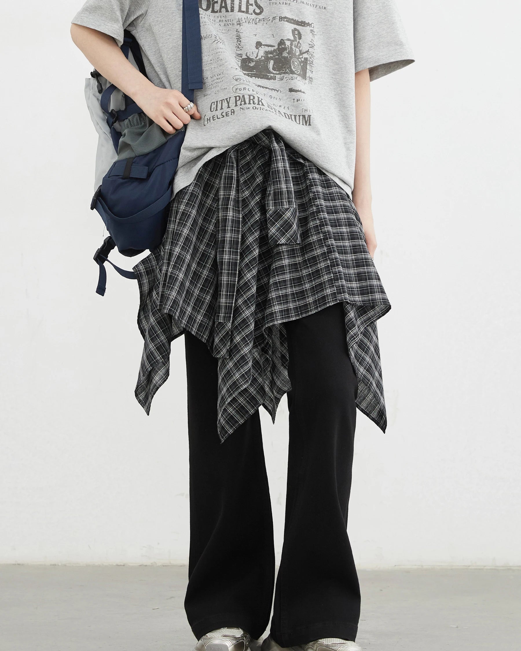 Plaid asymmetric A-line skirt in 100% cotton with elastic waist & tie detail. Classic British-inspired style for autumn & winter dressing.
