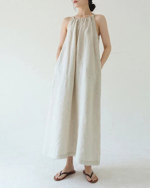 100% linen halter-neck maxi dress with back bandage tie and relaxed A-line silhouette. Naturally breathable & cool — a refined summer essential.