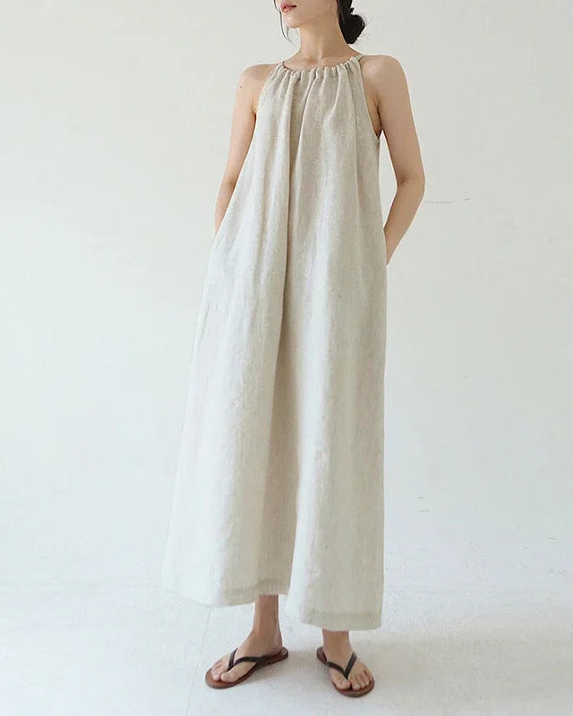 100% linen halter-neck maxi dress with back bandage tie and relaxed A-line silhouette. Naturally breathable & cool — a refined summer essential.