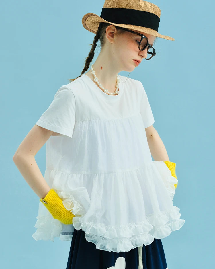 Our Lace Shoulder Spliced Tee — a relaxed women's top in breathable cotton-blend fabric with delicate sheer lace shoulder panels. Slight stretch, loose fit.
