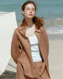  A relaxed loose-fit button-down shirt crafted from a breathable linen blend. This lightweight top features a classic collar and airy texture, perfect for effortless summer style and staying cool in warm weather.
