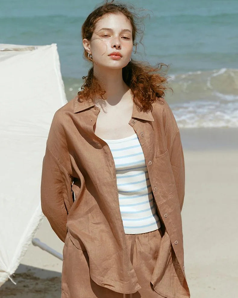  A relaxed loose-fit button-down shirt crafted from a breathable linen blend. This lightweight top features a classic collar and airy texture, perfect for effortless summer style and staying cool in warm weather.