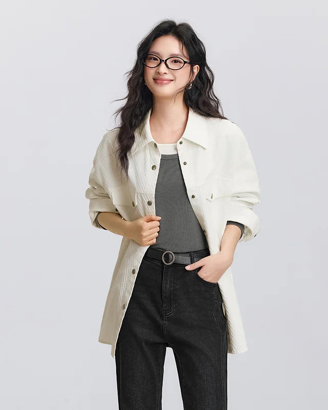 Relaxed mid-length cotton shirt with diamond jacquard texture, dropped shoulders, and buttoned cuffs.
