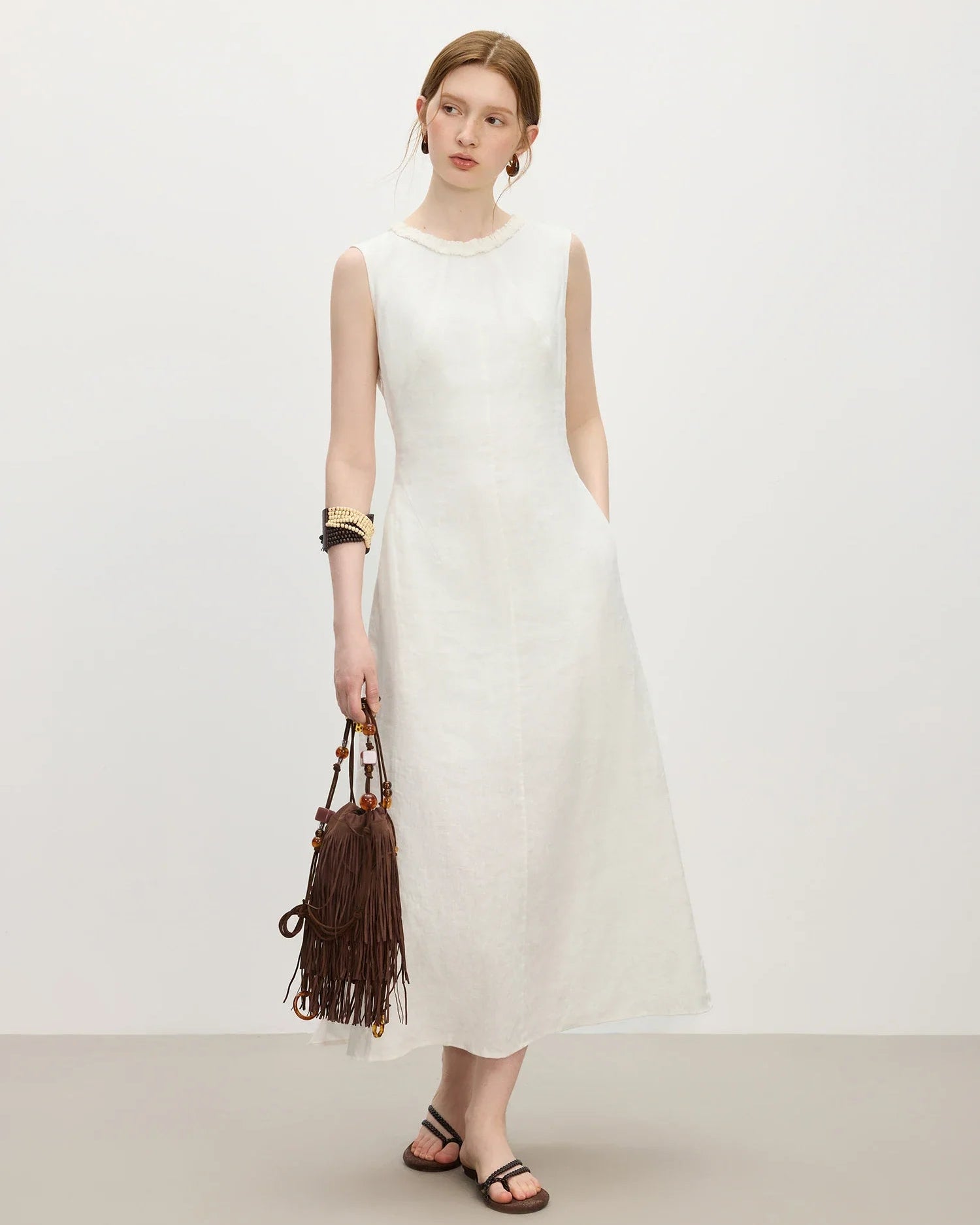Women's linen wood-ear edge round neck sleeveless dress in ivory, featuring a breathable structured drape for spring and summer layering or resort wear from dawn brunch to dusk dining.
