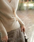 Designers' V-neck Wool Sweater with Asymmetrical Buttons