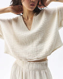  A lightweight loose-fit V-neck cotton gauze t-shirt designed for women. This breathable summer top features a soft, sheer texture and relaxed silhouette, offering effortless comfort and a casual,