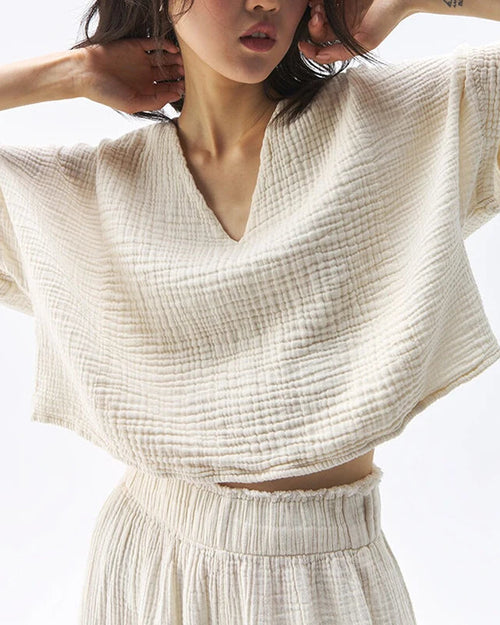  A lightweight loose-fit V-neck cotton gauze t-shirt designed for women. This breathable summer top features a soft, sheer texture and relaxed silhouette, offering effortless comfort and a casual,