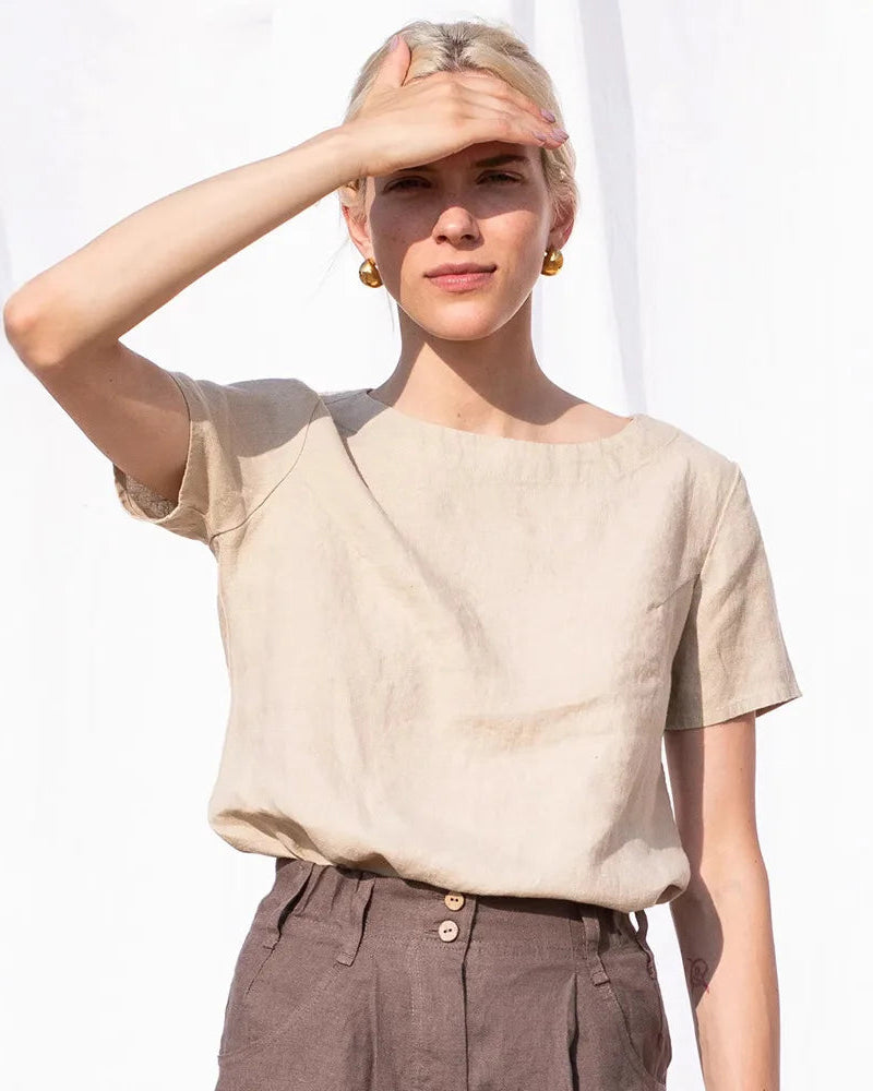 A loose-fit round neck cotton linen t-shirt designed for summer comfort. This lightweight top features a soft blend of breathable cotton and linen, offering a relaxed drape perfect for warm weather.