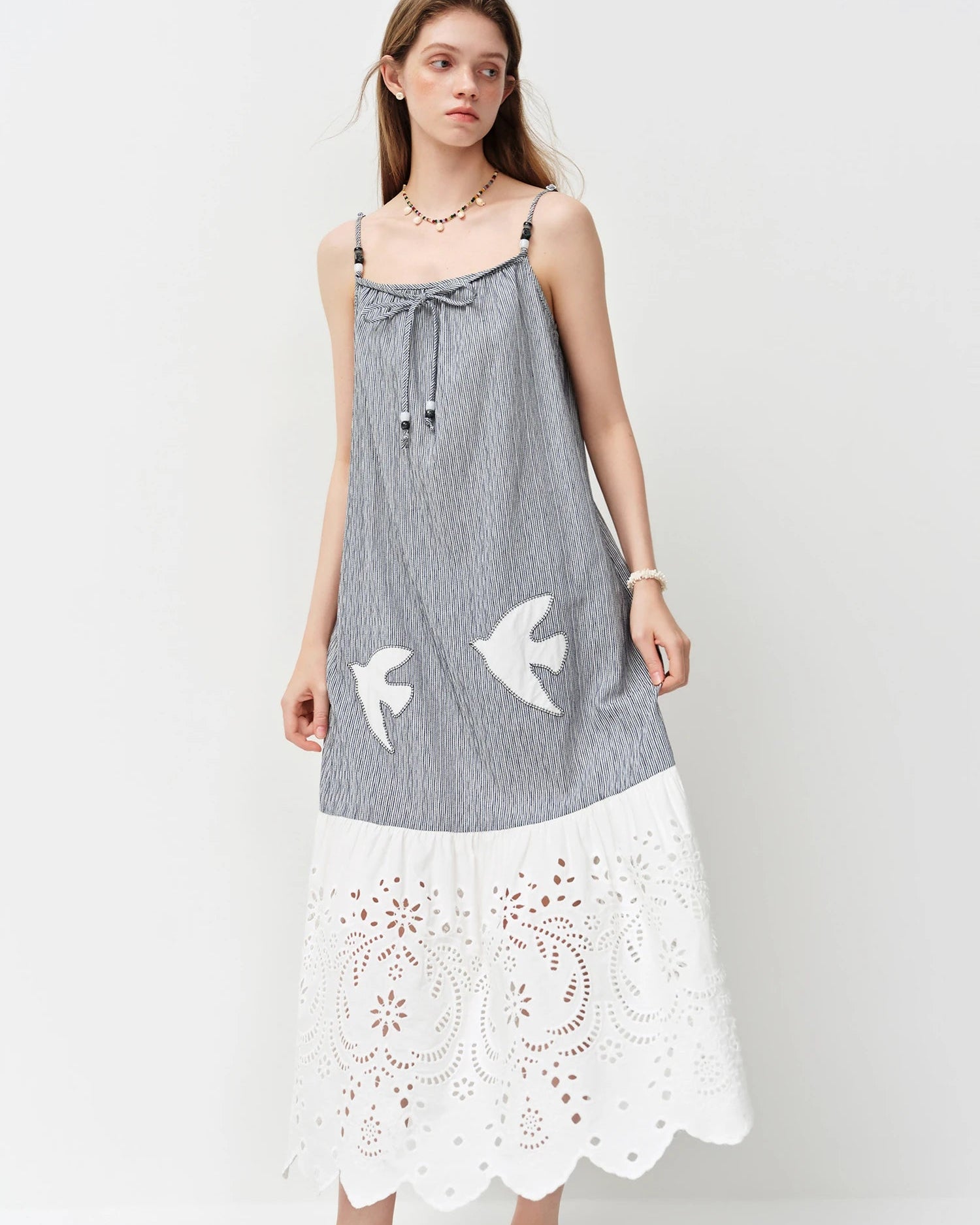 Sleeveless empire waist midi dress in a soft cotton-blend knit. Straight silhouette, mid-calf length.