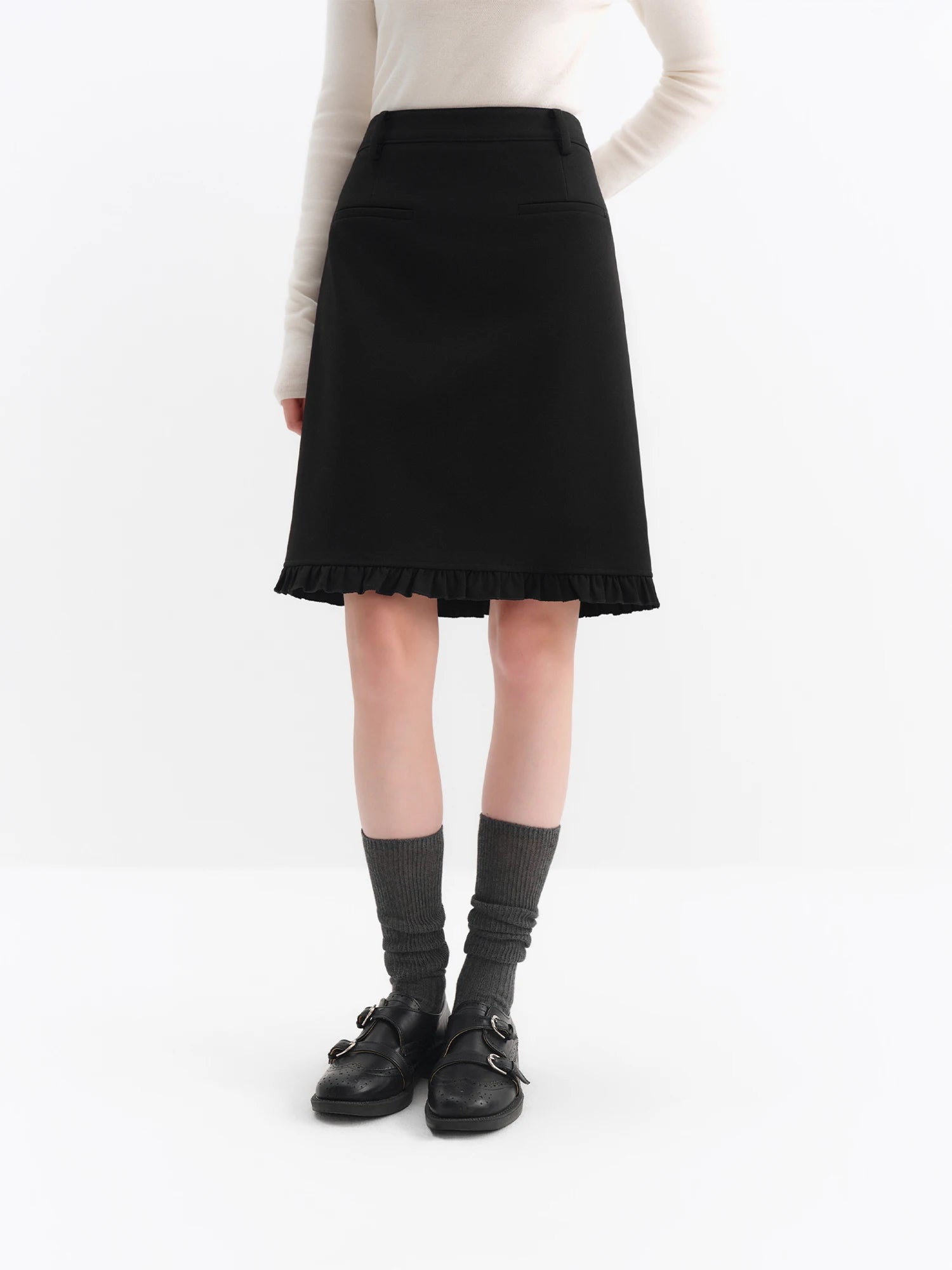Elegant black A-line midi skirt with ruffled hem. Flattering knee-length silhouette in breathable blended fabric. Perfect for office and everyday wear.