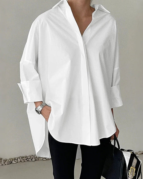 Stylish solid high-low shirt with an oversized fit and clean collar detail, offering versatile pairing options for smart-casual or laid-back summer occasions.