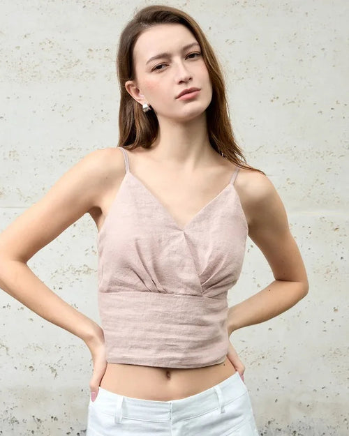 A stylish linen V-neck cropped vest featuring delicate spaghetti straps. This lightweight summer top is crafted from breathable linen fabric, offering a chic, airy fit perfect for hot weather and layering over tees or tanks.
