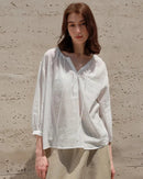Lightweight ramie-lyocell blouse with V-neck & drawstring waist. Breezy nine-quarter sleeves for effortless casual style, beach days & holiday escapes.