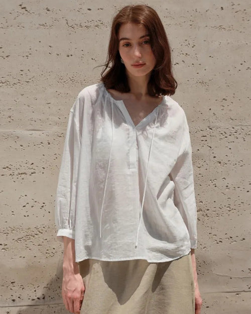 Lightweight ramie-lyocell blouse with V-neck & drawstring waist. Breezy nine-quarter sleeves for effortless casual style, beach days & holiday escapes.