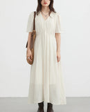 This soft, viscose-nylon blend vintage V-neck puff sleeve loose-fitting dress features delicate pleated details and an ankle-length drape, making it perfect for an elegant summer office look or a casual, romantic everyday style.