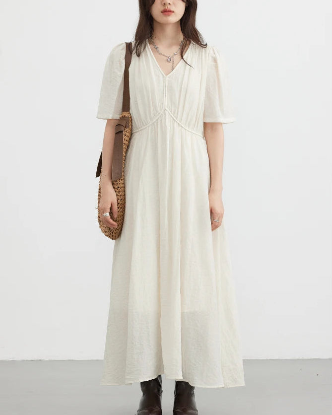 This soft, viscose-nylon blend vintage V-neck puff sleeve loose-fitting dress features delicate pleated details and an ankle-length drape, making it perfect for an elegant summer office look or a casual, romantic everyday style.