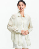 Relaxed mid-length shirt with full ink wash botanical print, classic lapel, and soft polyester-viscose blend. 
