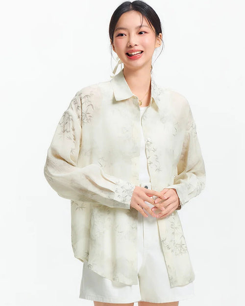 Relaxed mid-length shirt with full ink wash botanical print, classic lapel, and soft polyester-viscose blend. 
