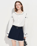 Vintage-inspired white shirt with delicate embroidered lace and a Peter Pan collar. Loose fit, flared sleeves .