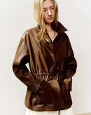 Cropped moto-style jacket in viscose-metallic blend with drawstring waist & turn-down collar. Flattering, fashion-forward outerwear for spring & autumn.