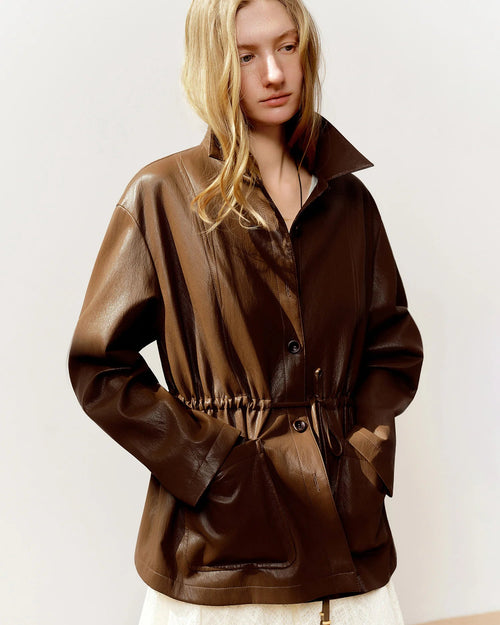 Cropped moto-style jacket in viscose-metallic blend with drawstring waist & turn-down collar. Flattering, fashion-forward outerwear for spring & autumn.