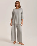 Women's Knit short-sleeve pajama set crafted from soft viscose-elastane fabric, featuring a round neck top and ankle-length pants that deliver poised comfort from evening wind-down to lazy weekend mornings.