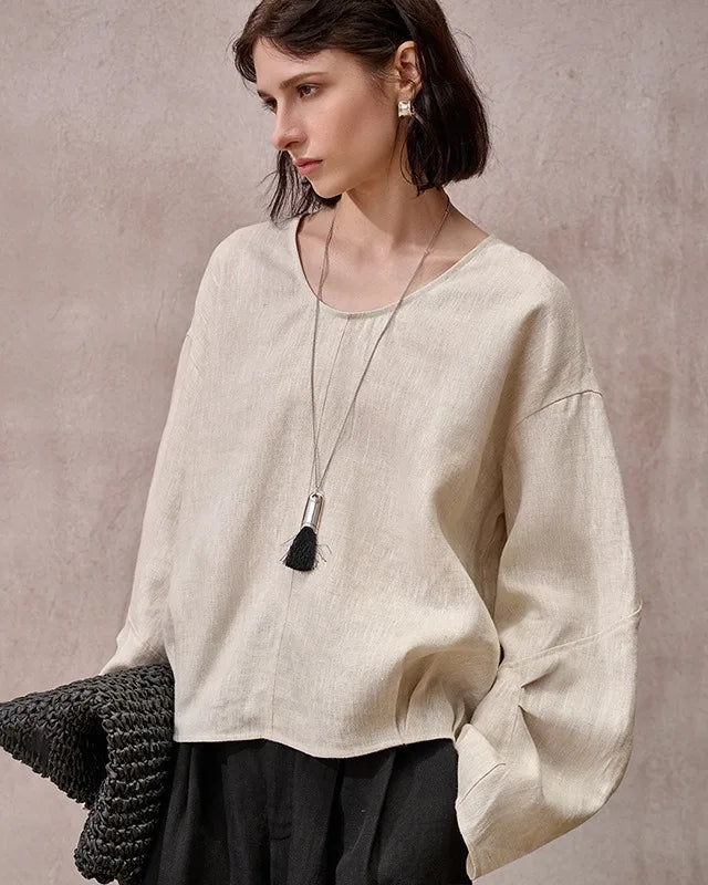 A relaxed loose-fit linen crew neck shirt featuring a classic round collar. This lightweight summer top is made from breathable linen fabric, offering a comfortable drape and cool feel perfect for casual warm weather wear.