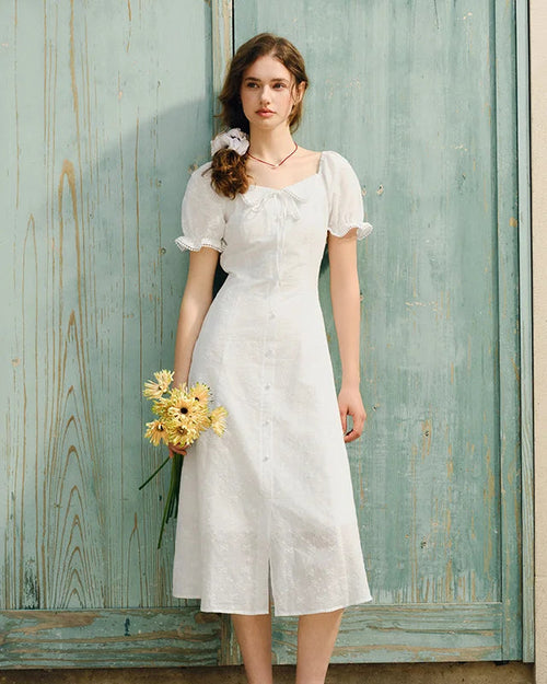 Elegant white cotton dress with puff sleeves, lace Peter Pan collar, and full-panel embroidery. 
