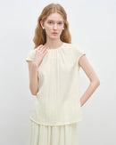 Women's light yellow round neck loose sleeveless top, featuring breathable acetate blend and fluid drape for summer brunch or casual wear comfort.