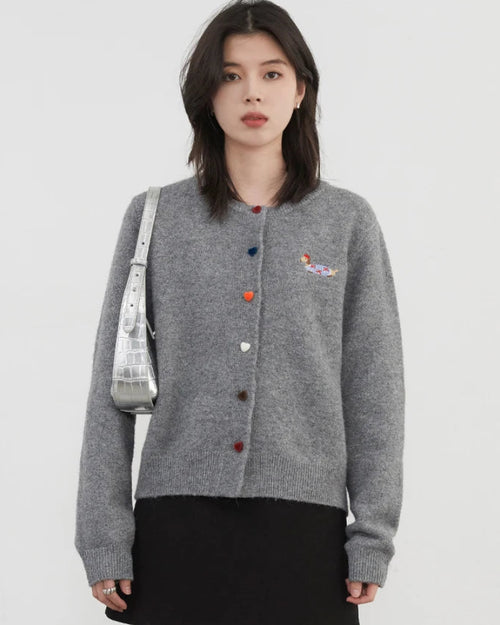 Relaxed knit cardigan for women in Gray and Oatmeal. Loose casual fit with round neck, full sleeves and love button detail. Versatile layering piece for spring and autumn.
